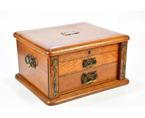 WALKER &amp; HALL; an Art Nouveau oak cased table canteen of silver plated cutlery, the case with brass applied floral decora