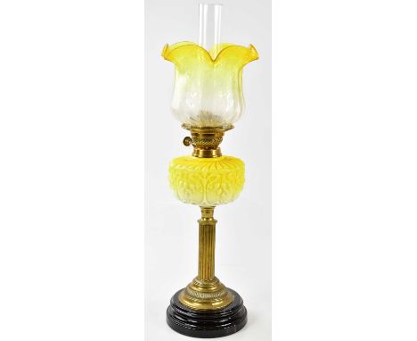 A Victorian oil lamp, the vaseline and clear glass shade with etched floral decoration and wavy rim, with the moulded glass r