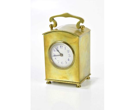 A late 19th century brass cased carriage clock, with swing handle above the arched top case, the enamel dial set with Arabic 