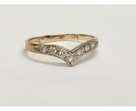 A vintage 9ct gold and diamond wish bone ring with case. Size O. 1.25 grams. 