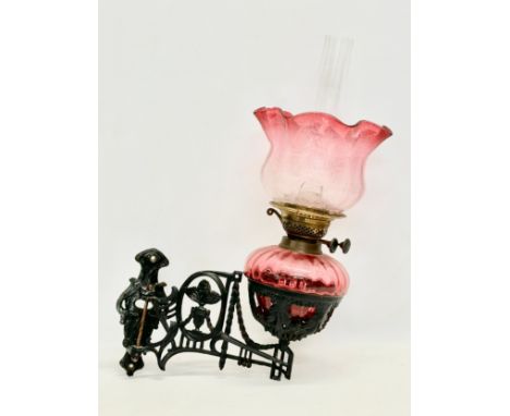 A Victorian wall bracket oil lamp with Ruby Glass bowl and shade. 34x50cm 