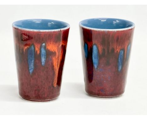 A pair of Poole Pottery mugs. 9.5cm 