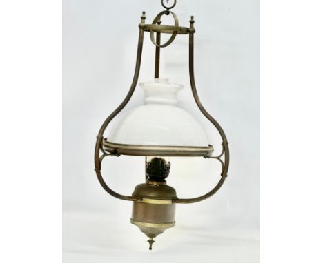 An early 20th century hanging brass oil lamp with glass shade. 37x75cm 
