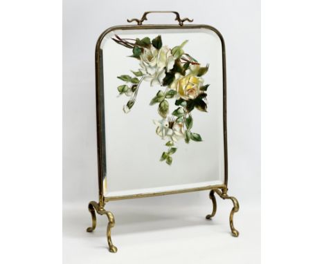 An Edwardian brass framed firescreen with painted mirror. 38x20x59cm 