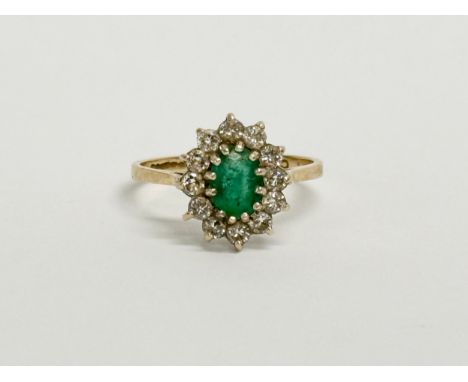 A 9ct gold emerald cluster ring. Size N. 