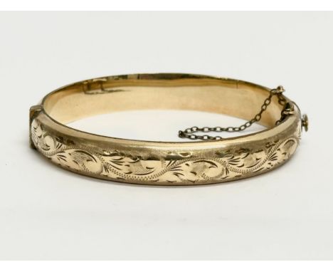 A vintage rolled gold bangle with case. 