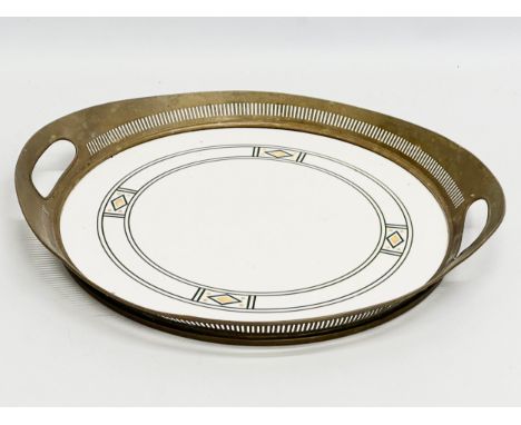 An Art Nouveau ceramic tray with pierced brass frame by WMF Wächtersbach, Germany. Circa 1910. Stamped Dec 1891 80. 36.5x33cm