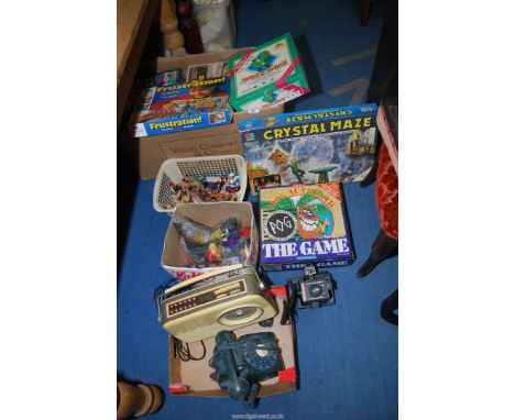 Four boxes of miscellanea including children's toys, board games, Bush radio, Polaroid camera etc.
