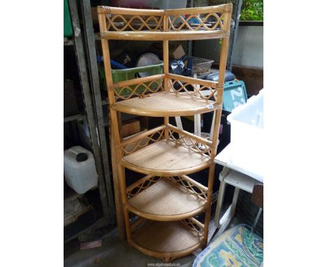 A bamboo five shelf corner unit.