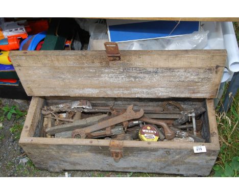 A tool box containing old tools, whetstones files, spanners, etc.