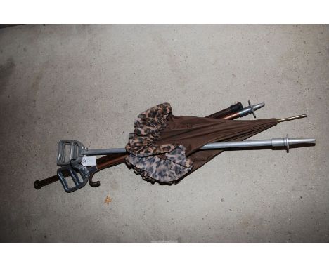 Two shooting sticks, an umbrella and walking stick. 