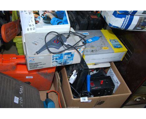 A box containing a battery charger, a "Vulcan" electric grinder, a record deck, transformer and professional engraver.