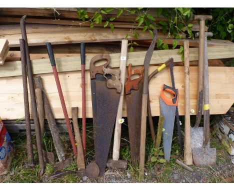 A quantity of tools to include: saws, a crowbar, etc.