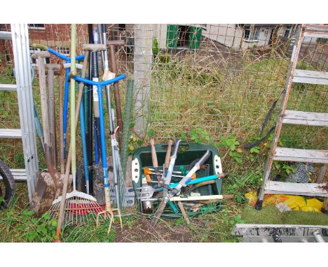 A quantity of garden tools to include: bulb planter, shovels, spades, etc.