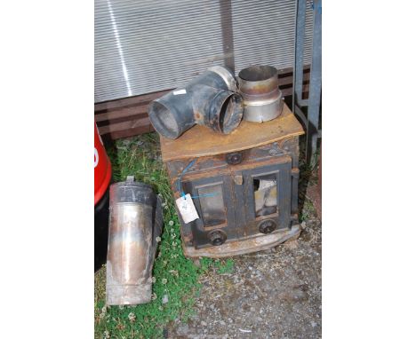 A cast iron multi fuel stove with flue pipe, a/f.