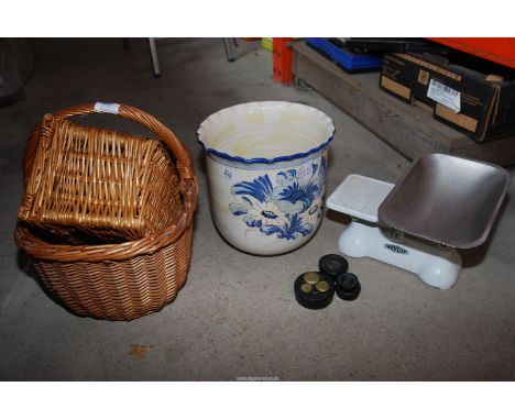 Two baskets, a large planter and scales with weights.