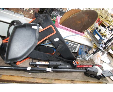 Two hedge trimmer attachments and a long armed Chainsaw attachment plus "Stihl" harness.