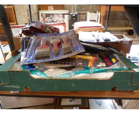 A large box of DIY/decorating items to include paint brushes, wall plugs, waste pipe, hand sander etc.