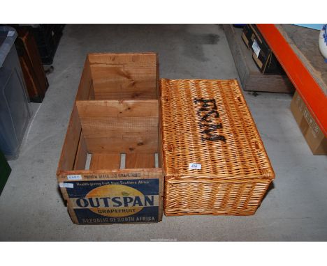 An empty Fortnum and Mason picnic hamper and an orange Outspan wooden box.