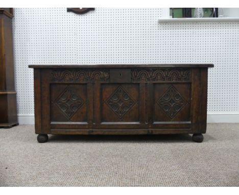 A 17thC and later oak three-panel Coffer, with carved frieze and three carved panels, on bun feet, with alterations,&nbsp;rep