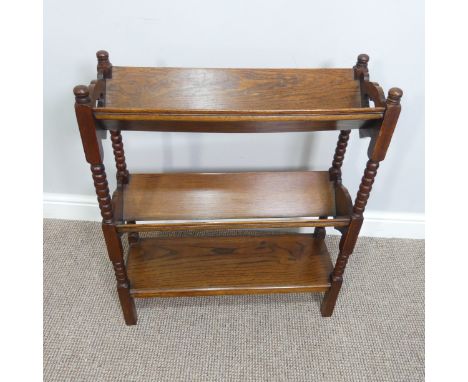 An Arts and Crafts oak three-tier Book Trough, with bobbin-turned supports and pierced with heart-shaped motifs, W:61cm x H:7