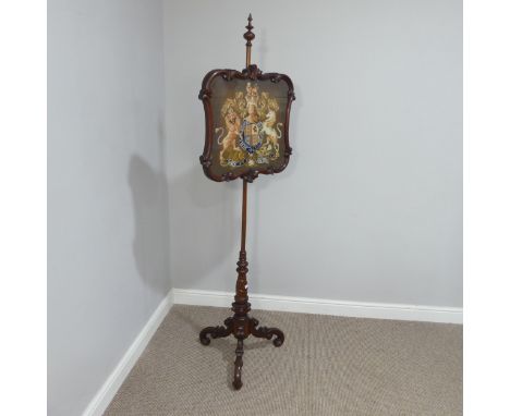 A Victorian mahogany tapestry Pole Screen, with turned column on carved tripod base, the tapestry depicting the Royal Coat of