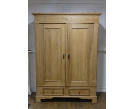 An antique pine double Wardrobe, with panel doors and two drawers, on bracket feet, W:148cm x H:203cm x D:60cm. 