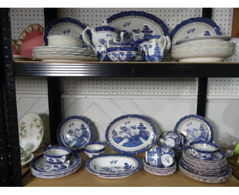 A Booths Willow Pattern Dinner and Tea Service, comprising a Teapot, three Jugs, six Cups and Saucers, Sugar Bowl, Slop Bowl,