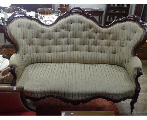 A Victorian mahogany framed three seater button back Sofa, of shaped and pierced serpentine form with floral upholstery, fram