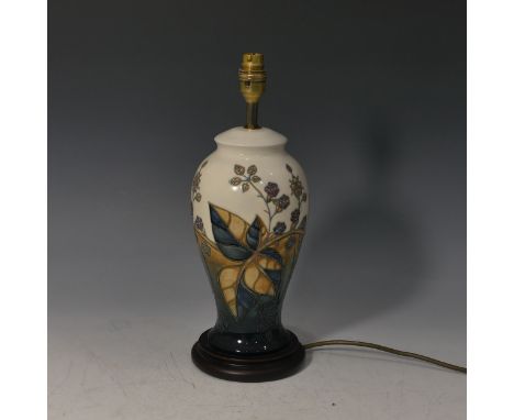 A Moorcroft 'Bramble' pattern Table Lamp, tube lined decoration on a blue and cream ground, H 38cm (without shade). 