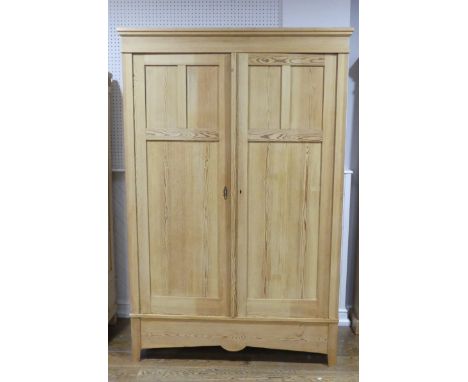 An antique pine double Wardrobe, with panel doors and shaped apron, W:125cm x H:205cm x D:63cm. 