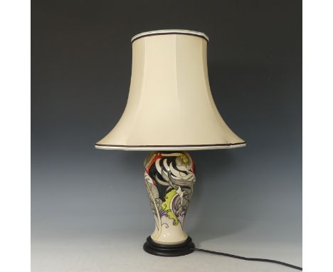 A Moorcroft floral Table Lamp and Shade, tube lined floral decoration on blue and cream ground, with original factory tags, H