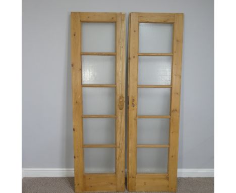 A pair of vintage pine five-panel glazed internal doors, with dimpled glass, each door 55cm wide x 197cm high (2) 