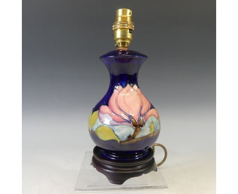 A Moorcroft 'Hibiscus' pattern Lamp Base, tubelined decoration on blue ground, on wooden base, H 25cm overall. 