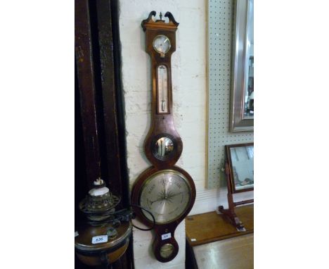A Georgian mahogany wheel barometer.