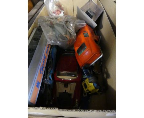 A box of assorted toy cars, Action Man figure, and other mixed items.