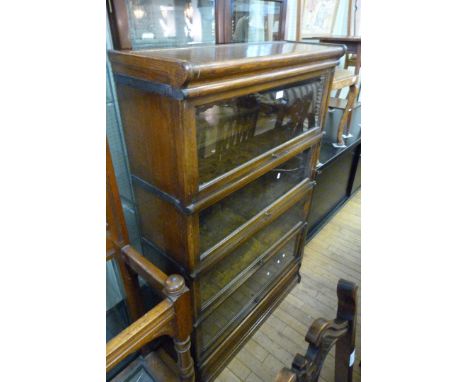 A mid Century Globe Wernicke oak four tier bookcase, with up and over glazed doors.
