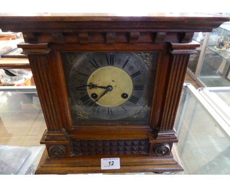 An early 20th Century mantel clock in architectural carved case.