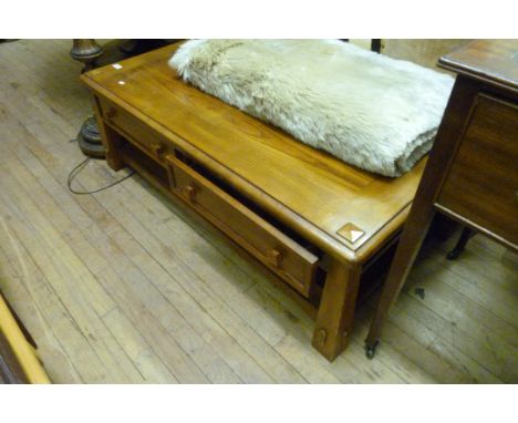 A modern light oak effect coffee table, having undertier shelf.