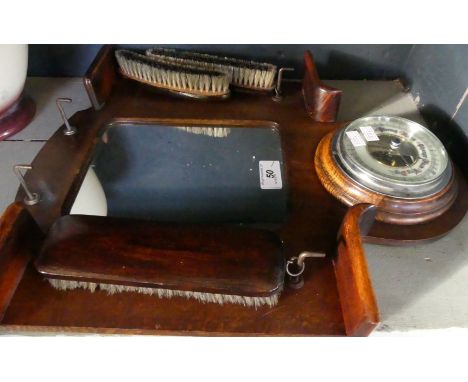 An early 20th Century oak wall mounted combination aneroid barometer mirror and brush stand 