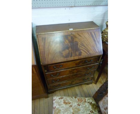 A reproduction flame mahogany bureau, the fall front enclosing fitted interior with green leather section above four drawers,