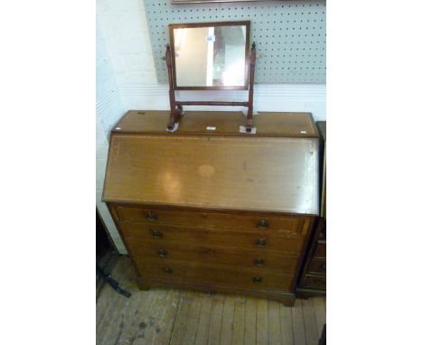 A late 19th Century Sheraton revival inlaid mahogany bureau, the fall front enclosing fitted interior above four drawers, rai