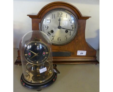 A mahogany cased arched topped mantel clock with presentation plaque dated 1928, together with a further modern domed mantel 
