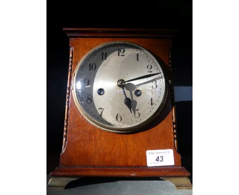 An early 20th Century mahogany cased mantel clock, with brass movement, striking on a gong.