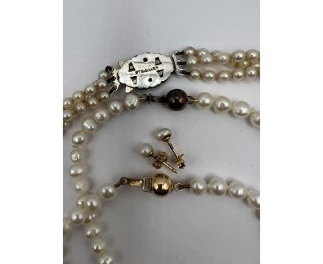 A selection of cultured pearl jewellery comprising a 3 strand necklace with a marcasite and silver clasp in a vintage case, a