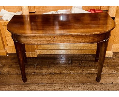 A George III mahogany D-end console table, circa 1800, raised on tapering supports. 76cm H x 120cm W x 59cm D&nbsp;