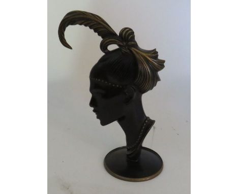 Richard Rohac (1906-1956) An Austrian patinated bronze model of a female profile head with feathered headdress on a circular 