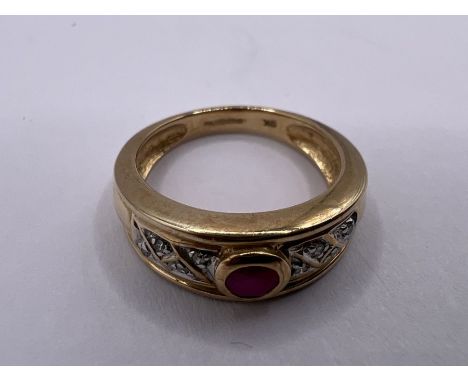 A 9ct gold diamond and ruby ring. Approximate gross weight 3.3 grams. Size K.