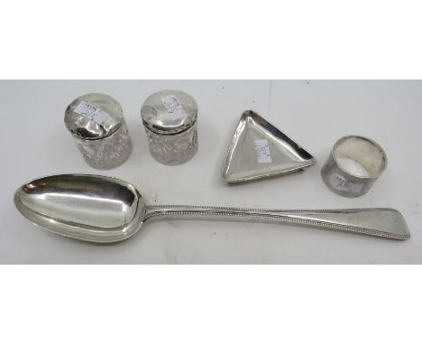 A Victorian silver basting spoon with beaded border by George Adams, London 1865, a triangular pin tray, engine turned napkin