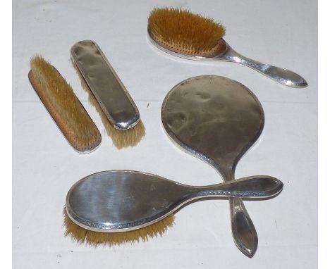 An engine turned silver dressing table set by Mappin and Webb, London 1915, comprising hand mirror, a pair of hairbrushes and